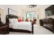 Spacious main bedroom with king bed, sitting area, and large window at 9260 Swaying Branch Rd, Sarasota, FL 34241