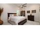 Cozy bedroom with a double bed, dark wood furniture, and large window at 9260 Swaying Branch Rd, Sarasota, FL 34241
