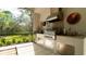 Stainless steel outdoor kitchen with granite countertops, perfect for entertaining at 9260 Swaying Branch Rd, Sarasota, FL 34241