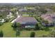 Aerial view featuring a private pool and lanai with mature landscaping and a golf course and a pond in the community at 10209 Discovery Ter, Bradenton, FL 34212