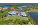 Aerial view of a community with a golf course, marina, clubhouse, and beautiful landscaping at 10209 Discovery Ter, Bradenton, FL 34212