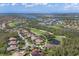 Stunning aerial view of a luxurious home encircled in white, nestled within a golf course community near waterways at 10209 Discovery Ter, Bradenton, FL 34212