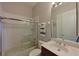 Bright bathroom featuring a tub with shower, a single sink vanity, a mirror, and neutral wall color at 10209 Discovery Ter, Bradenton, FL 34212
