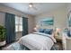 Calming bedroom with a queen bed, blue accents, and ample natural light at 10209 Discovery Ter, Bradenton, FL 34212