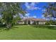 Charming single-story home with a well-manicured lawn, elegant columns, and a tile roof at 10209 Discovery Ter, Bradenton, FL 34212