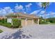 Stunning home featuring a spacious three-car garage and beautifully paved driveway, surrounded by lush landscaping at 10209 Discovery Ter, Bradenton, FL 34212