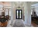 Grand foyer with soaring ceilings, elegant columns, and a statement chandelier at 10209 Discovery Ter, Bradenton, FL 34212