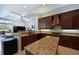 Gourmet kitchen featuring granite countertops, custom cabinets, and stainless steel appliances at 10209 Discovery Ter, Bradenton, FL 34212