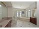 Bright main bathroom with a glass block shower, large soaking tub, and dual vanities at 10209 Discovery Ter, Bradenton, FL 34212