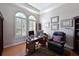 Well-lit office with custom built-ins, hardwood floors, and comfortable furniture at 10209 Discovery Ter, Bradenton, FL 34212