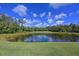 Picturesque pond view with lush greenery, capturing the serene beauty of the golf course setting at 10209 Discovery Ter, Bradenton, FL 34212