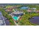 Aerial shot of a community pool, clubhouse, and surrounding waterways, offering a resort-style living experience at 10209 Discovery Ter, Bradenton, FL 34212