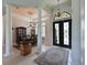 Grand entryway with high ceilings, elegant chandelier, and double doors at 10209 Discovery Ter, Bradenton, FL 34212