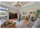 Bright living room with hardwood floors, comfy seating, and large windows at 10209 Discovery Ter, Bradenton, FL 34212