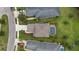 Aerial view of the home featuring a well manicured lawn, mature landscaping, and a sparkling private pool at 12224 Longview Lake Cir, Bradenton, FL 34211