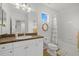 Bright bathroom featuring a vanity with solid surface countertops and shower with updated tile and hardware at 12224 Longview Lake Cir, Bradenton, FL 34211