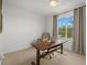 Bright office with large window, neutral paint, carpet, and work-from-home desk and ergonomic chair at 12224 Longview Lake Cir, Bradenton, FL 34211