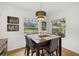 Bright dining room with backyard views, featuring a modern table and seating for six at 12224 Longview Lake Cir, Bradenton, FL 34211