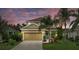 Charming two-story home with a well-manicured front yard, two car garage, and inviting blue front door at 12224 Longview Lake Cir, Bradenton, FL 34211
