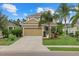 Charming two-story home with mature landscaping, a covered front porch, and an attached two-car garage at 12224 Longview Lake Cir, Bradenton, FL 34211