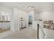 Upstairs hallway with laundry closet, decorative shelving, and views to the bathroom and office spaces at 12224 Longview Lake Cir, Bradenton, FL 34211