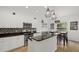Modern kitchen features white cabinets, stainless steel appliances, and a breakfast bar at 12224 Longview Lake Cir, Bradenton, FL 34211
