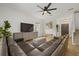 Comfortable living room features a large leather couch, TV, tile floors, and natural light at 12224 Longview Lake Cir, Bradenton, FL 34211
