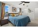 Spacious bedroom with ample natural light, ceiling fan, carpet flooring and ensuite bathroom at 12224 Longview Lake Cir, Bradenton, FL 34211