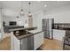 Modern kitchen with white cabinets, granite countertops, and island at 12224 Longview Lake Cir, Bradenton, FL 34211