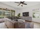 Living room featuring a leather sectional and view of the pool at 12224 Longview Lake Cir, Bradenton, FL 34211