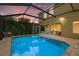 Relaxing pool with screened enclosure, featuring an outdoor seating area, and tropical landscaping at 12224 Longview Lake Cir, Bradenton, FL 34211