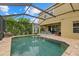 Enjoy this home's in-ground pool with screened enclosure, brick paver deck, exterior dining area, and outdoor sofa seating at 12224 Longview Lake Cir, Bradenton, FL 34211