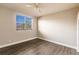Bright bedroom with wood-look floors and large window at 14106 18Th E Pl, Bradenton, FL 34212