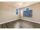 Well-lit bedroom with wood-look floors and arched window at 14106 18Th E Pl, Bradenton, FL 34212