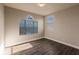 Simple bedroom with hardwood floors and an arched window at 14106 18Th E Pl, Bradenton, FL 34212