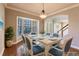 Virtually staged dining room with white table and blue chairs at 14106 18Th E Pl, Bradenton, FL 34212