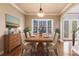 Virtually staged dining room with wood table and six chairs at 14106 18Th E Pl, Bradenton, FL 34212