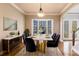 Virtually staged dining room with modern white table and chairs at 14106 18Th E Pl, Bradenton, FL 34212