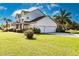 Two-story house with a three-car garage and lush landscaping at 14106 18Th E Pl, Bradenton, FL 34212