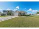 Home exterior with a welcoming front yard and pond view at 15218 Agave Grove Pl, Bradenton, FL 34212