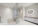 Luxurious bathroom with soaking tub, glass shower, and modern vanity at 1561 Gulf Of Mexico Dr # 403, Longboat Key, FL 34228