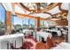 Bright dining area with white tablecloths, modern chairs, and ocean views at 1561 Gulf Of Mexico Dr # 403, Longboat Key, FL 34228
