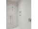 Elegant shower with marble-look tile and built-in shelving at 1561 Gulf Of Mexico Dr # 403, Longboat Key, FL 34228