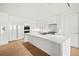 Modern kitchen with white cabinets and marble counters at 1561 Gulf Of Mexico Dr # 403, Longboat Key, FL 34228