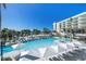 Resort-style pool with plenty of lounge chairs and umbrellas at 1561 Gulf Of Mexico Dr # 403, Longboat Key, FL 34228