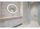 Contemporary bathroom with a large vanity and illuminated mirror at 1561 Gulf Of Mexico Dr # 403, Longboat Key, FL 34228
