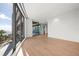 Large bedroom with wood floors and access to balcony at 1561 Gulf Of Mexico Dr # 403, Longboat Key, FL 34228