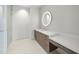 Modern bathroom with double vanity, large mirror, and glass shower at 1561 Gulf Of Mexico Dr # 403, Longboat Key, FL 34228