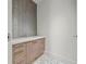 Stylish powder room with floating vanity and pebble tile floor at 1561 Gulf Of Mexico Dr # 403, Longboat Key, FL 34228
