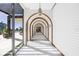 Elegant hallway with arched doorways and tile floors at 1561 Gulf Of Mexico Dr # 403, Longboat Key, FL 34228